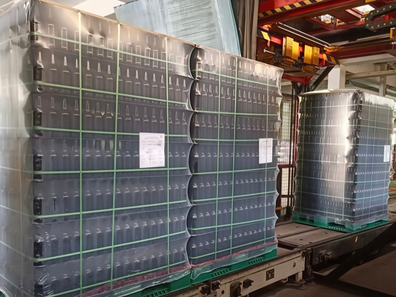 Palletized goods wrapped with PE shrink hood film for industrial and logistics packaging protection